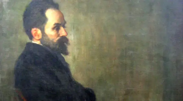 Portret mężczyzny z brodą i wąsami, w ciemnym ubraniu. Widać jego profil. Szymon Gajowiec poglądy.